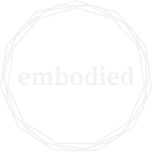 The word embodied in white with four white jagged circles around it